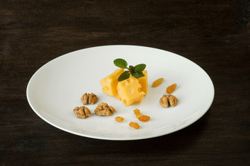 the pieces of the cheese with raisin and walnuts
