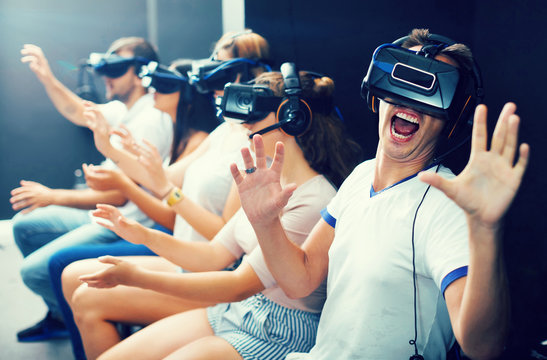 Excited  man experiencing with friends virtual reality