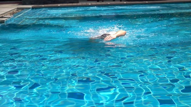 Man swimming in the pool, slow motion shot at 240fps
