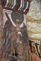wall murals of saints and iconographic scenes, painted in naive african christian style, on wall of Abuna Yemata Guh church 