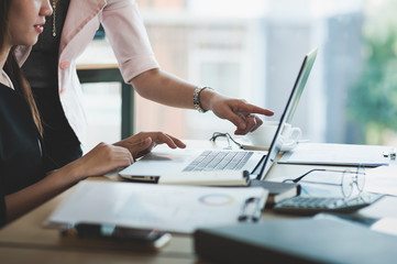 Young Asian women workers working together in office