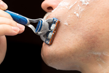 The man is shaving with foam machine