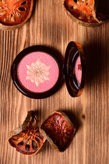 Opened blusher on white wooden table