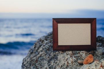 Photo frame stone, sea at sunset place for lettering, copyspace