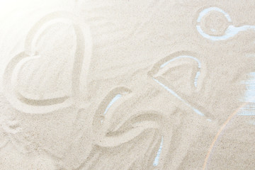 spa handwritten in sand on a beach.