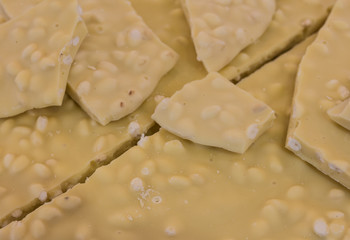 White chocolate whit hazelnut. Close-up. Selective focus