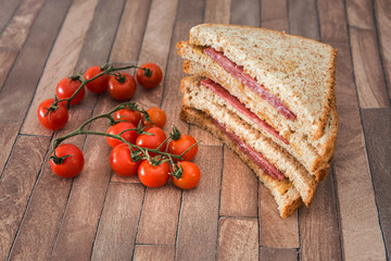 Wholemeal bread sandwich topped with Lyon rosette and butter