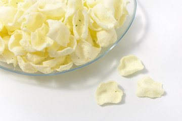 golden potato chips on a white background.