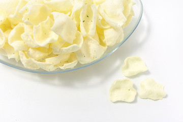 golden potato chips on a white background.