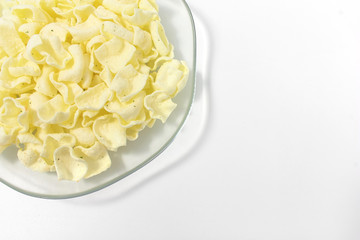 golden potato chips on a white background.