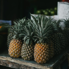 ripe delicious pineapples on market stall in Bali, Indonesia