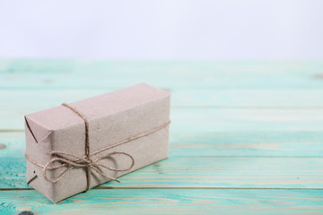 Presents for any holiday concept. Border of decorative gifts wrapped kraft paper tied with tourniquet for christmas, valentine day or birthday