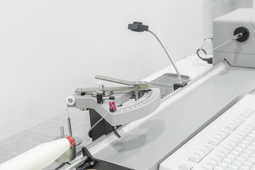 laboratory equipment measures the quality of cotton thread for strength in a textile factory. close up