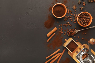 Top view on old coffee mill, scattered beans and spices, background with copy space