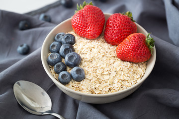 Oatmeal with fresh fruit. Strawberry and blueberry.
