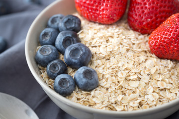 Oatmeal with fresh fruit. Strawberry and blueberry.
