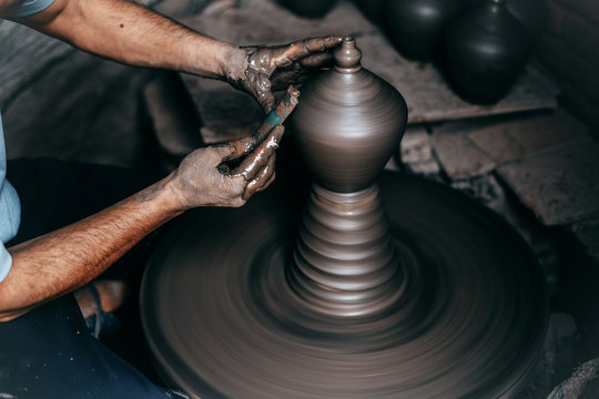 potter hands doing clay bowl on wheel