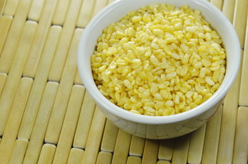 baked soybean in white cup on bamboo plate background