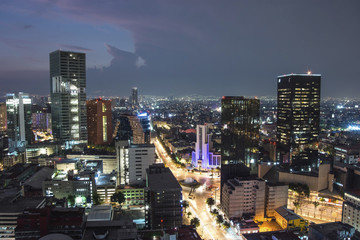 Aerial view of mexico city downtown skyscrappers at sunset time before night.