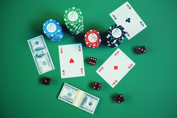 3D illustration playing chips, cards and money for casino game on green table. Real or Online casino concept.