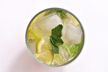 Fresh and cold mahito cocktail on a white background top view