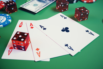3D illustration casino game. Chips, playing cards for poker. Poker chips, red dice and money on green table. Online casino concept.