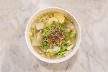 Top view of boiled tofu soup with minced pork on granite table background