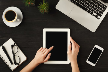 Woman's hands using digital tablet, top view