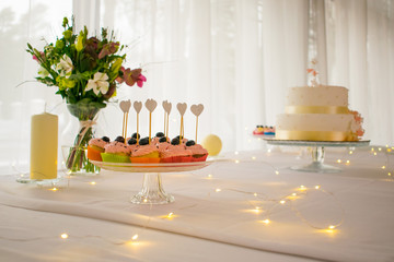 Cupcakes and flowers with led lights on white table decoration