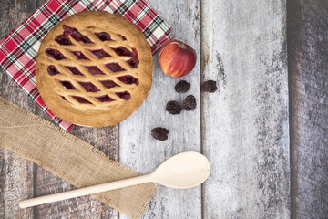 Apple and Blackberry pie on a wooden background with apples and blackberries 