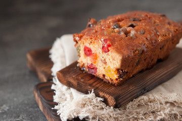 Traditional fruit cake pudding with dried fruits on wooden board