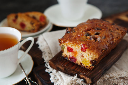 Traditional fruit cake pudding with dried fruits on wooden board