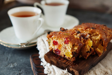 Traditional fruit cake pudding with dried fruits on wooden board