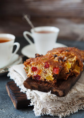 Traditional fruit cake pudding with dried fruits on wooden board