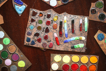 Multicolored enamel samples on metal, top view