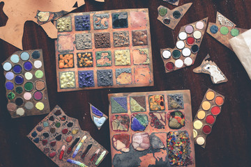 artist's studio samples of enamels on table, top view
