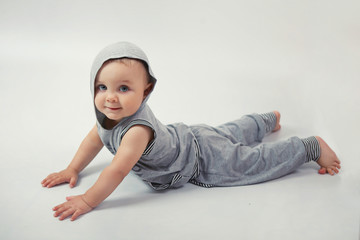 Little boy doing exercise in Studio on white background