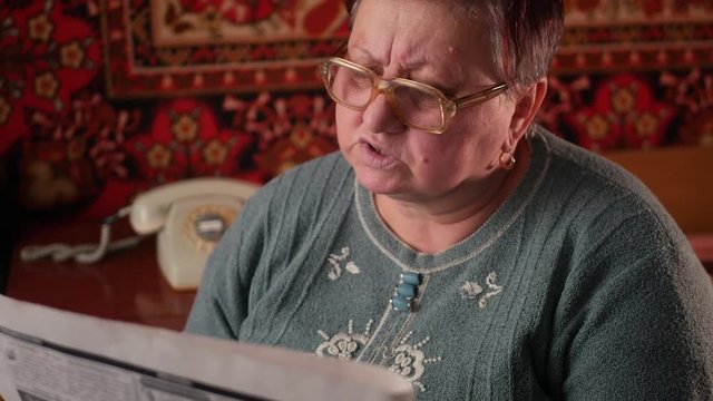 Senior woman reading newspaper
