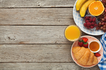 Tasty pastry, fruits and berries on rustic wood, top view