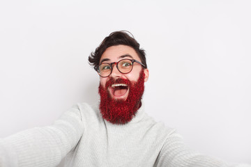 Excited crazy hipster with glowing beard