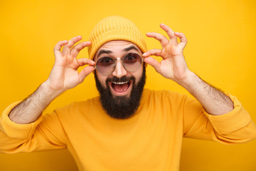 Cheerful hipster trying sunglasses