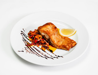 plate with fried fish salad and lemon.