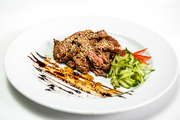 meat salat on a plate with cucumber and tomato