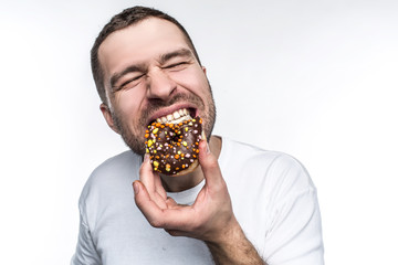 Big guy is starving. He decided to eat tasty small fat donut covered with chocolate. He is biting...