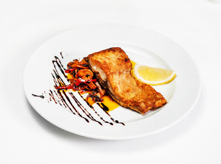 plate with fried fish salad and lemon