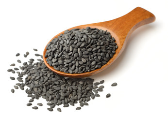 black sesame seeds in the wooden spoon, isolated on white
