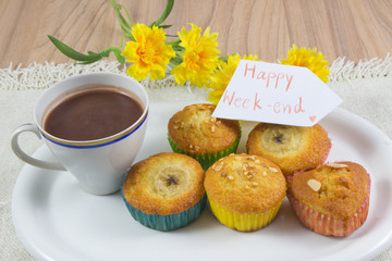 Enjoying your free time with hot cocoa, hot chocolate for drink in white plate on a wooden table with sweet dessert and notebook with pen background, Happy week- end concept.