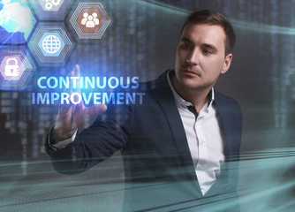 Business, Technology, Internet and network concept. Young businessman working on a virtual screen of the future and sees the inscription: Continuous improvement