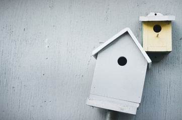 Wooden birdhouse on fence in country garden 
