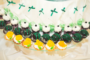 Delicious sweets on wedding candy buffet with desserts, cupcakes